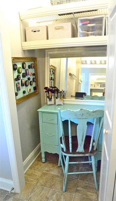 a blue desk and chair are in the corner of a room with a mirror above it