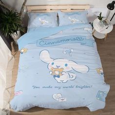 a bed with a blue comforter that has an elephant on it and the words, you make my world brighter