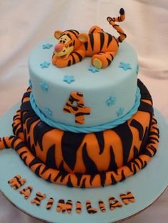 a blue and orange cake with a tiger on top