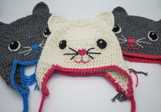 three crocheted hats with cats on them