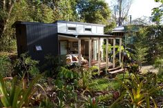 the small house is surrounded by trees and plants