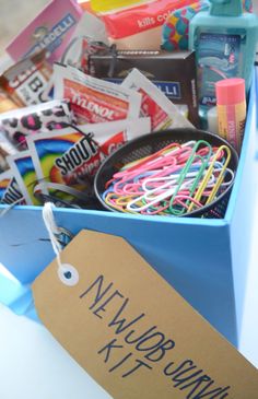 a blue box filled with lots of different types of crafting supplies and paper clips