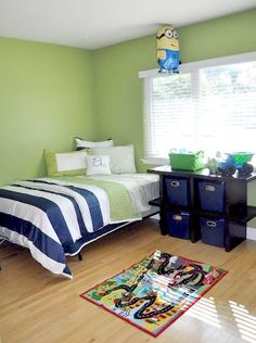 a bedroom with green walls and wooden floors, two twin sized beds are in the corner