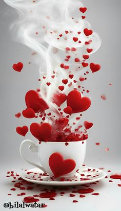 a cup filled with lots of red hearts on top of a saucer