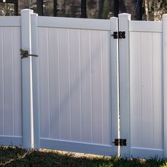 an image of a white fence that is in the grass