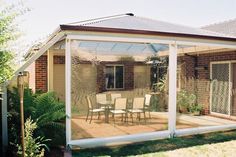 an enclosed patio with table and chairs