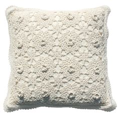 a white crocheted pillow on a white background