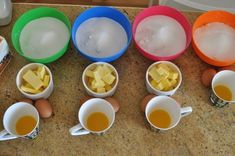 several bowls filled with different types of food on top of a counter next to eggs