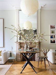 a living room filled with furniture and a fire place in the middle of the room