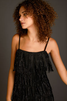 This suede mini dress is perfect for a night out on the town. With its sleeveless design, fringed detail, and embellished accents, this dress is sure to turn heads. Whether you're hitting up a club or going to a fancy dinner, this mini dress is a great choice. You'll look and feel fabulous in this amazing dress. Fringed Mini Dress For Night Out, Summer Mini Dress With Rhinestone Fringe For Night Out, Chic Sleeveless Dress With Beaded Fringe, Club Mini Dress With Fringe For Party Season, Sleeveless Flapper Dress With Tassels For Night Out, Glamorous Sleeveless Mini Dress With Tassels, Glamorous Sleeveless Flapper Dress With Tassels, Glamorous Beaded Fringe Dress For Date Night, Sleeveless Fringe Mini Dress For Party