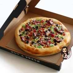 a pizza sitting inside of a box on top of a table