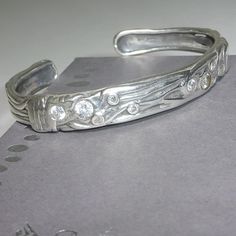 Beautiful Sterling Silver Cuff Bracelet With Intricate Carved Design And Inset Cubic Zirconia Stones. This Is A Rare And Limited Edition Piece Which Was Awarded To A Select Number Of Silpada Representatives. It Was Not Sold To The Public. The Bracelet Measures Approx. 2 3/8" Inside Width X 1/4" Height. Marked With The Silpada Logo And .925 Inside The Bracelet. .925 Sterling Silver, Cubic Zirconia Excellent Condition. The Bracelet Pictured Is The One You Will Receive. Packaged In Generic Materials. Silpada Box Available Upon Request. Silpada Jewelry, Sterling Silver Cuff Bracelet, Sterling Silver Cuff, Silver Cuff Bracelet, Silver Cuff, Womens Jewelry Bracelets, Cuff Bracelet, Cubic Zirconia, Silver Bracelet