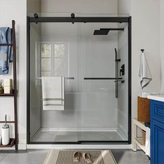 a bathroom with a walk in shower next to a blue cabinet