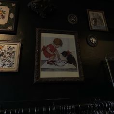 there are pictures on the wall with clothes hanging