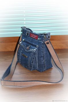 a purse made out of old jeans is sitting on the floor