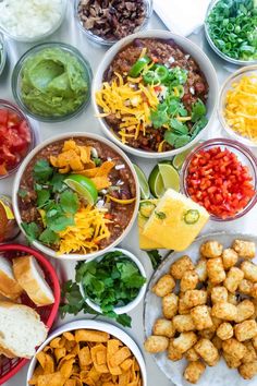 many bowls filled with different types of food