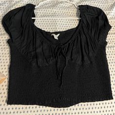 Smocked Bodice, Flowy On The Cups And Sleeves, Tie Detail In Front Very Stretchy Black Smocked Top For Vacation, Black Smocked Back Top For Vacation, Black Top With Smocked Back For Vacation, Black Tops With Smocked Back For Vacation, Fitted Black Smocked Top For Vacation, Casual Black Smocked Top For Vacation, Black Ruched Top For Vacation, Black Summer Smocked Top With Smocked Back, Black Smocked Back Top For Summer