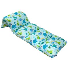 a child's sleeping bag with dinosaurs on it and blue fabric, sitting in front of a white background