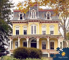 a large yellow house with many windows on it's front and side porchs