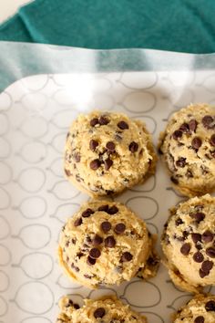 chocolate chip cookies sitting on top of a white plate