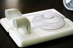 a white object sitting on top of a wooden table