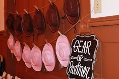 hats are hanging on the wall next to a sign that says gear up nation and hangs from clothes pins