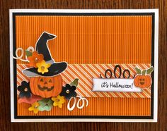 an orange card with a pumpkin and witch hat