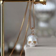 💀PEARLS: Genuine White Freshwater Pearl 💀SIZE: Ranging in size, from 10 to 11mm excluding the bail 💀NECKLACE : -14Kt Yellow Gold Filled - Box Chain 1mm 18 - 24 inches -925 Sterling Silver - Box Chain 1mm 18 - 24 inches -14K Yellow Gold - 1.2 mm Rounded Box Chain 18 inches 💀BAIL METAL: 14k Yellow Gold Filled 925 Sterling Silver 14k Yellow Gold 💀 BAIL SIZE: The gold-filled bail is 5 mm Sterling Silver bail is 5 mm. 14k gold bail is 5 mm Please contact me if you need to customize it. 💀 Authentic Metal Quality Guaranteed! Rest assured that all the metal qualities mentioned in the description are accurately represented. Occasionally, due to the small size of the product, a hallmark may not be stamped onto the item. You can verify the authenticity of the metal at any local jewelry store. W Luxury Skull Jewelry For Gifts, Luxury Skull Shaped Jewelry For Gift, White Skull Shaped Jewelry Gift, Pearl Skull, Carved Pearl, Fantasy Earrings, Gothic Pendant, Vintage Jewelry Necklace, Jewelry White