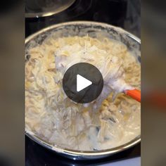 a video demonstrating how to cook pasta in a pot on the stove with an orange spatula