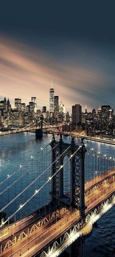 an aerial view of the brooklyn bridge at night