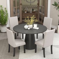 a dining room table with four chairs around it