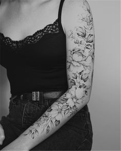 a woman's arm with flowers on it