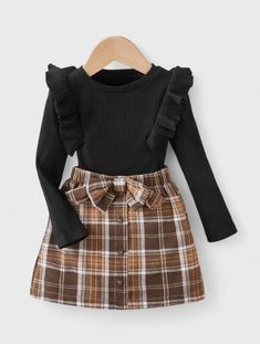 Get your little one ready for the holidays with our Ribbed Knit Ruffle Trim Top & Belted Plaid Flannel Skirt set. Perfect for Christmas, this festive outfit features a cozy ribbed knit top with delicate ruffle trim, paired with a classic plaid flannel skirt complete with a stylish belt. Your child will look adorable and feel comfortable, making this ensemble ideal for holiday gatherings and festive celebrations. Costum Elegant, Plaid Skirt Set, Long Sleeve Ruffle Top, Flannel Skirt, Ribbed Shirt, Black Children, Plaid Bow