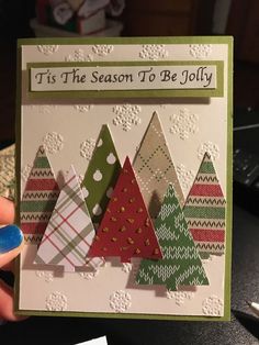 someone holding up a christmas card that says tis the season to be jolly