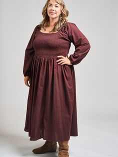 This is a modified version of our Teddy Midi dress, with long sleeves for chillier days. This midi dress features pretty sleeves, an elastic bodice with a flattering fit, and hidden pockets. Cut from a rich, yarn-dyed maroon cotton, this subtle print is a stunner. 100% Cotton Small-batch yarn dyed fabric Hidden pockets Elasticated bodice Length from center front of size 2X is 46" Made fair trade in India by one of our longstanding production partners Fall Knee-length Dress With Smocked Bodice, Fall Dresses With Smocked Cuffs And Square Neck, Long Sleeve Dress With Gathered Sleeves For Fall, Fall Long Sleeve Dress With Gathered Sleeves, Fall Smocked Dress With Square Neck And Smocked Cuffs, Billowy Long Sleeve Maxi Dress For Daywear, Fall Square Neck Dress With Smocked Back, Midi Dress With Bishop Elastic Sleeves, Midi Smocked Dress For Gatherings