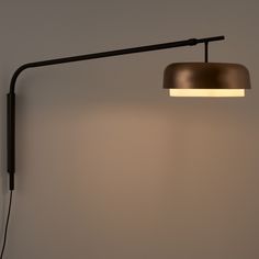 a wall lamp with a dimmer on the side and a black cord attached to it