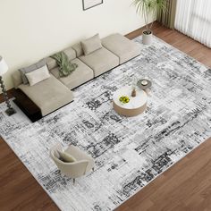 an aerial view of a living room area with couches, coffee table and rug