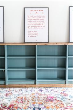 two blue bookcases sitting next to each other on top of a rug