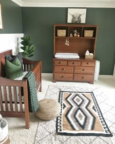 a baby's room with green walls and white carpet