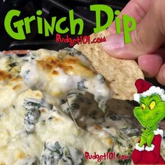 the grinch dip is being held up by someone holding a tortilla chip