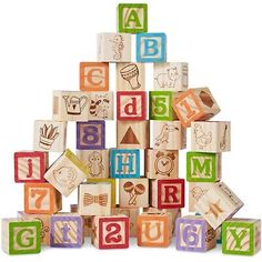 wooden blocks are stacked up in the shape of a pyramid with letters and numbers on them