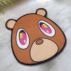 a brown teddy bear rug with big eyes