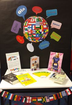 the table is covered with many different languages and flags, including letters that spell out countries