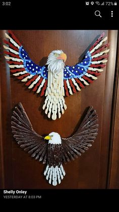 two eagle sculptures made out of wooden sticks and painted with american flag colors on them