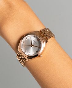 A classic design, elevated. The bold and urban Vivid watch features a statement round face with chunky outer casing that’s juxtaposed by the delicate sunray dial, minimalist numeral. In silver and white with a feminine rose gold twist and a 32mm face, Vivid is a powerful piece pairing androgynous design with robust links made of gold-plated stainless steel for effortless sophistication. Classic Watch For Woman, Trendy Everyday Watches, Trendy Rose Gold Watch With Round Dial, Minimalist Rose Gold Watch For Everyday, Everyday Rose Gold Quartz Watches, Trendy Rose Gold Everyday Watches, Chain Watches For Ladies, Classic Watch Women, Timepiece Design