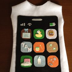 a cell phone case made out of felt with appliqued images on it