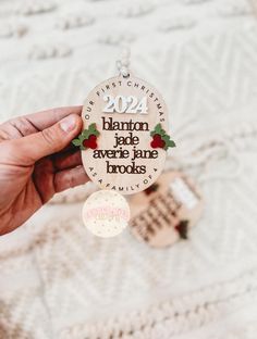 someone is holding up a christmas ornament with the words, santa fete averie jane brooks on it