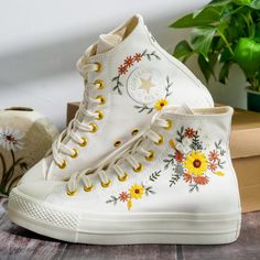 Custom Embroidered Converse Platform, Wedding Sunflowers Embroidered Shoes, Bridal Flowers Embroidered Converse, Flower Embroidered Sneakers for Bride, Flowers Embroidered Sneakers for Wedding 💚 Immerse yourself in the intricate craftsmanship as we lovingly hand embroider rustic flowers onto your chosen Converse pair 💚 🌿 The listed price encompasses both the Converse Shoes and the showcased Embroidery Designs. 1. MANUFACTURING PROCEDURE 🌿 Upon receiving your order, we initiate the shoe prepa Embroidered Converse Wedding, Sneakers For Wedding, Wedding Sunflowers, Converse Chuck 70s, Embroidered Sneakers, Embroidered Converse, Cute Converse, Converse Platform, Wedding Converse