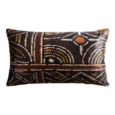 a black and gold pillow with an intricate design