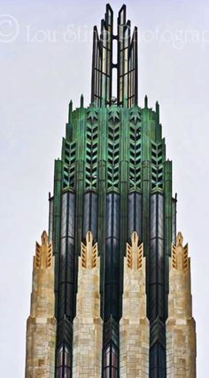 a very tall building with many windows on it's sides and a clock at the top